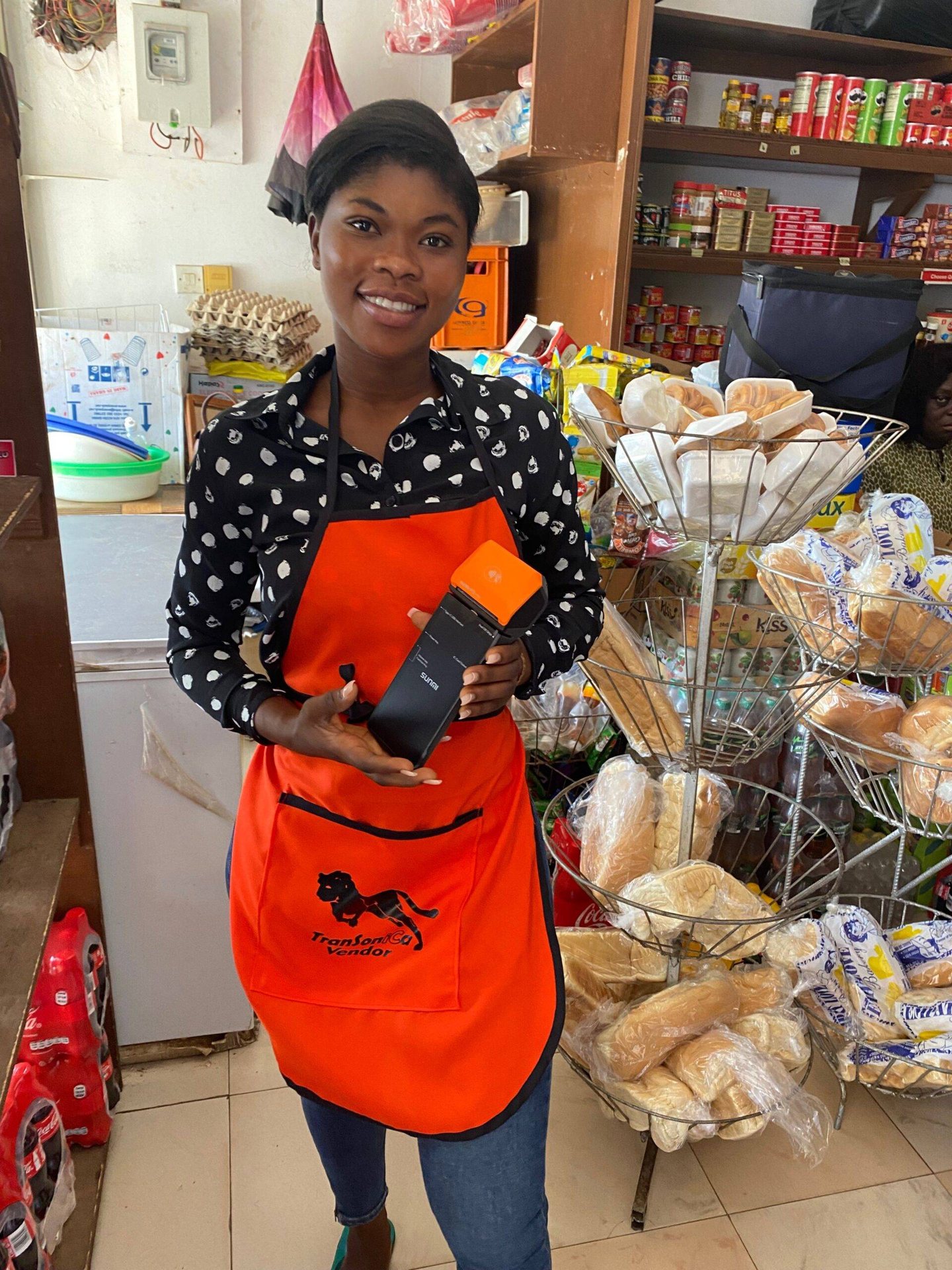 A TranSoniCa vendor holding a card in her shop